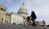A cyclist passes the the U.S. Capitol, on the day the House is expected to vote here to repeal Obamacare in Washington, D.C., U.S., May 4, 2017. REUTERS/Kevin Lamarque - RC149622B020