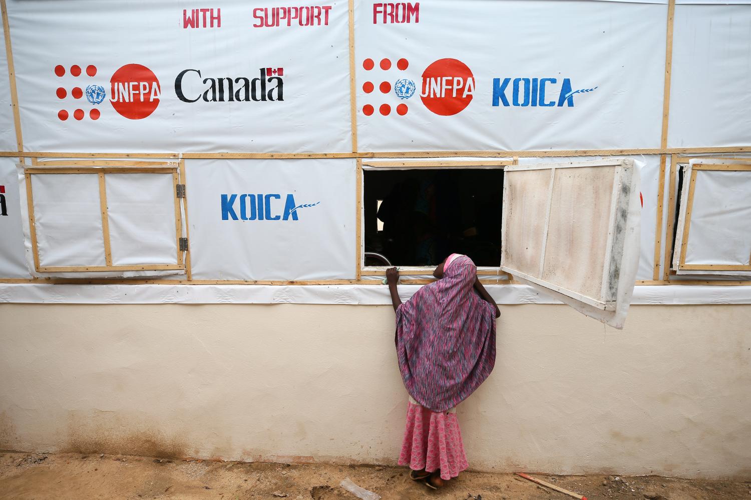 A girl looks through a window of a recovery ward at an obstetric fistula repair centre in Maiduguri, Nigeria August 1, 2018. Picture taken August 1, 2018. REUTERS/Afolabi Sotunde - RC1411E9FF70