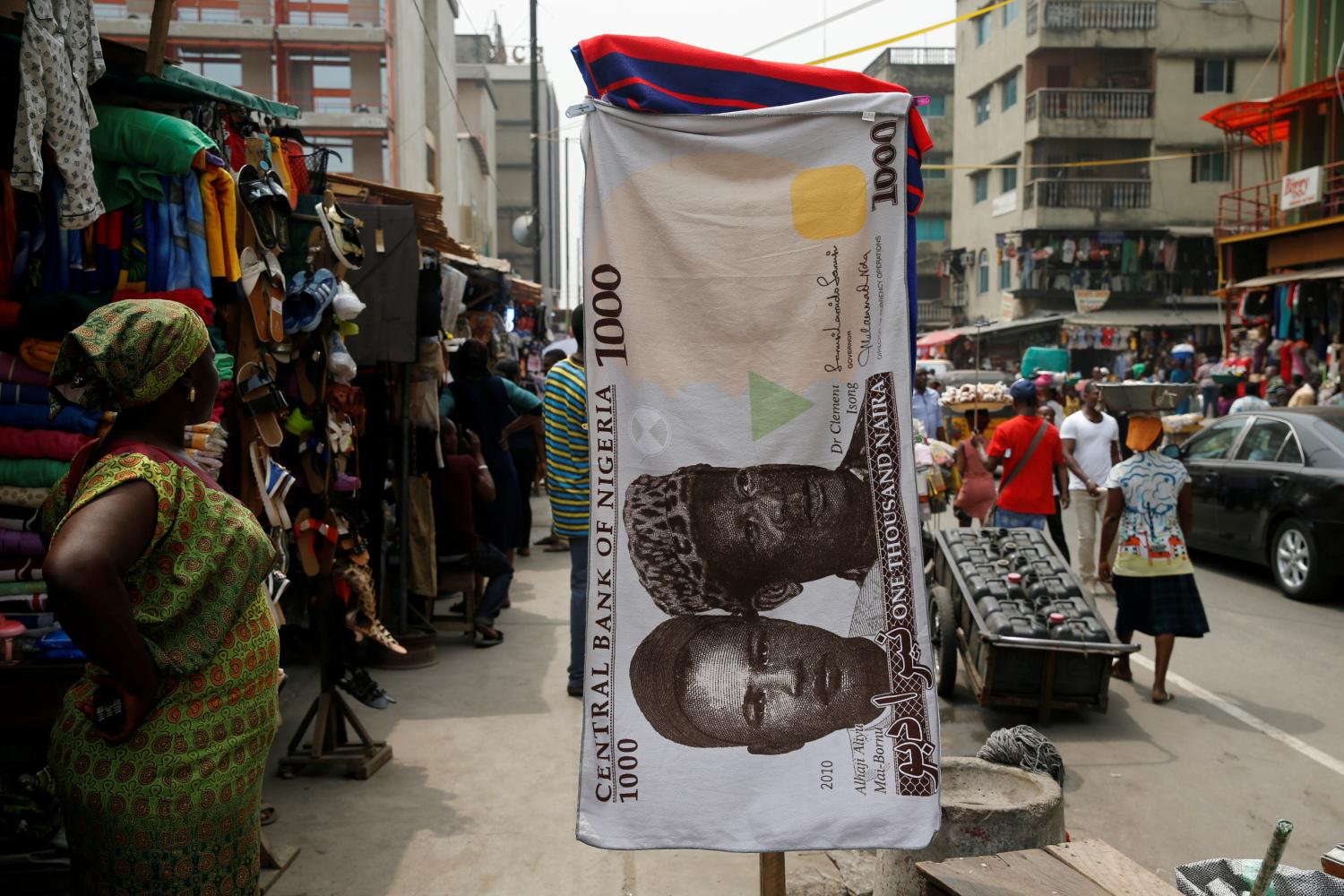 FILE PHOTO: A towel with a print of the Nigerian naira is displayed for sale at a street market in the central business district in Nigeria's commercial capital Lagos February 4, 2016. REUTERS/Akintunde Akinleye/File Photo - RC17DB8707D0
