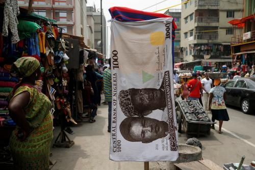 FILE PHOTO: A towel with a print of the Nigerian naira is displayed for sale at a street market in the central business district in Nigeria's commercial capital Lagos February 4, 2016. REUTERS/Akintunde Akinleye/File Photo - RC17DB8707D0