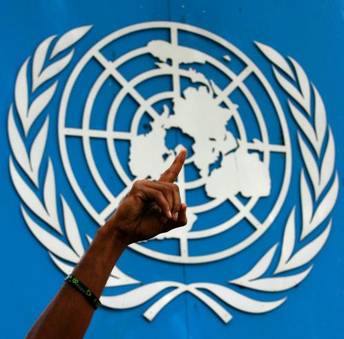 A protester gestures as he blocks the entrance to the United Nations headquarters with other protesters in Colombo July 6, 2010. The protesters on Tuesday blocked the entrance to the UN offices, trapping workers inside, to demand the immediate withdrawal of a panel advising UN Secretary General Ban Ki-Moon on whether war crimes were committed in the final months of Sri Lanka's war last year against separatist Tamil Tiger rebels. Ban appointed the three-member panel on June 22, 2010. REUTERS/Andrew Caballero-Reynolds  (SRI LANKA - Tags: CIVIL UNREST CRIME LAW POLITICS) - GM1E6761CKD01