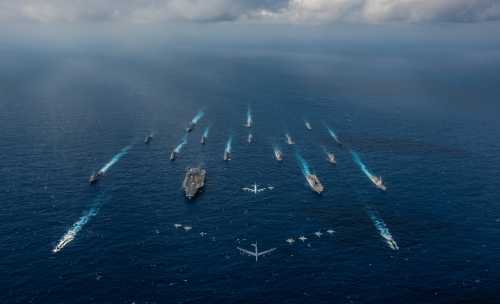 The aircraft carrier USS Ronald Reagan and the Japan Maritime Self-Defense Force helicopter destroyer JS Hyuga sail in formation with 16 other ships from the U.S. Navy and the Japan Maritime Self-Defense Force as aircraft from the U.S. Air Force and Japan Air Self-Defense Force fly overhead in formation during Keen Sword in the Philippine Sea November 8, 2018.  Picture taken November 8, 2018.  Courtesy Kaila V. Peters/U.S. Navy/Handout via REUTERS. ATTENTION EDITORS - THIS IMAGE HAS BEEN SUPPLIED BY A THIRD PARTY. - RC15D8F9E720