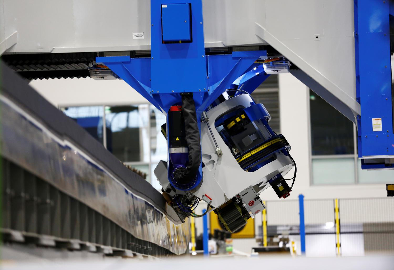 An electroimpact automated fiber placement machine, which lays down carbon fiber strips onto the 777X spar, seen during a media tour of the Boeing 777X at the Boeing Composite Wing Center in Everett, Washington, U.S., February 27, 2019. Picture taken February 27, 2019.  REUTERS/Lindsey Wasson - RC1B1FA69A40