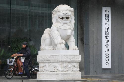 A man rides an electric bike past the China Banking and Insurance Regulatory Commission (CBIRC) building in Beijing, China February 14, 2019. Picture taken February 14, 2019. REUTERS/Stringer  ATTENTION EDITORS - THIS IMAGE WAS PROVIDED BY A THIRD PARTY. CHINA OUT. NO COMMERCIAL OR EDITORIAL SALES IN CHINA. - RC177131E7F0