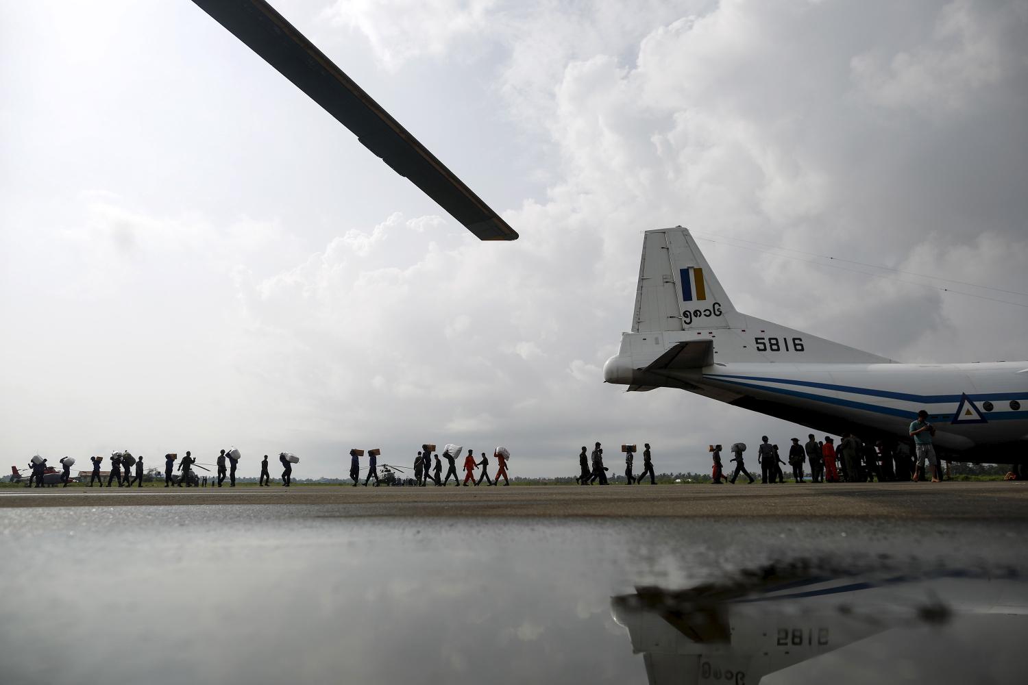 Soldiers and rescue workers unload aid from cargo aeroplane in Sittwe airpot at Sittwe, Rakhine state, August 5, 2015. The United States will announce an aid package for Myanmar to help the Southeast Asian country provide relief for the hundreds of thousands of people affected by floods, Secretary of State John Kerry said on Wednesday. More than 250,000 people have been affected and 69 killed by flooding that was triggered last week by monsoon rains, according to the Ministry of Social Welfare, Relief and Resettlement. REUTERS/Soe Zeya Tun - GF20000014051