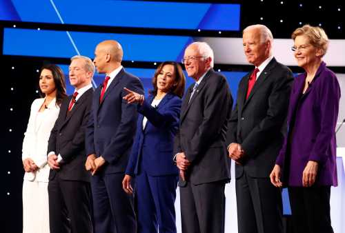 Democratic presidential candidates Rep. Tulsi Gabbard, billionaire activist Tom Steyer, Senator Cory Booker, Senator Kamala Harris, Senator Bernie Sanders, former Vice President Joe Biden and Senator Elizabeth Warren pose before the start of the fourth U.S. Democratic presidential candidates 2020 election debate at Otterbein University in Westerville, Ohio U.S., October 15, 2019. REUTERS/Aaron Josefczyk - HP1EFAG00N578