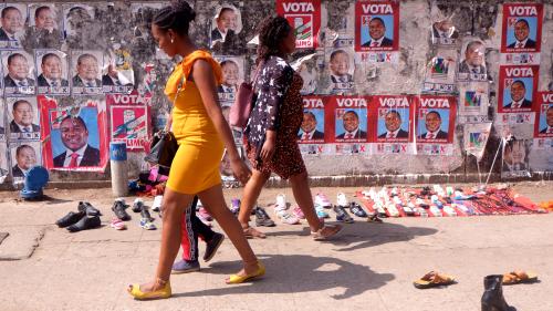 Mozambicans walk past election posters ahead Tuesday's provincial and legislative elections, in Maputo, Mozambique, October 11, 2019 REUTERS/Grant Lee Neuenburg - RC1D5F9B7C60