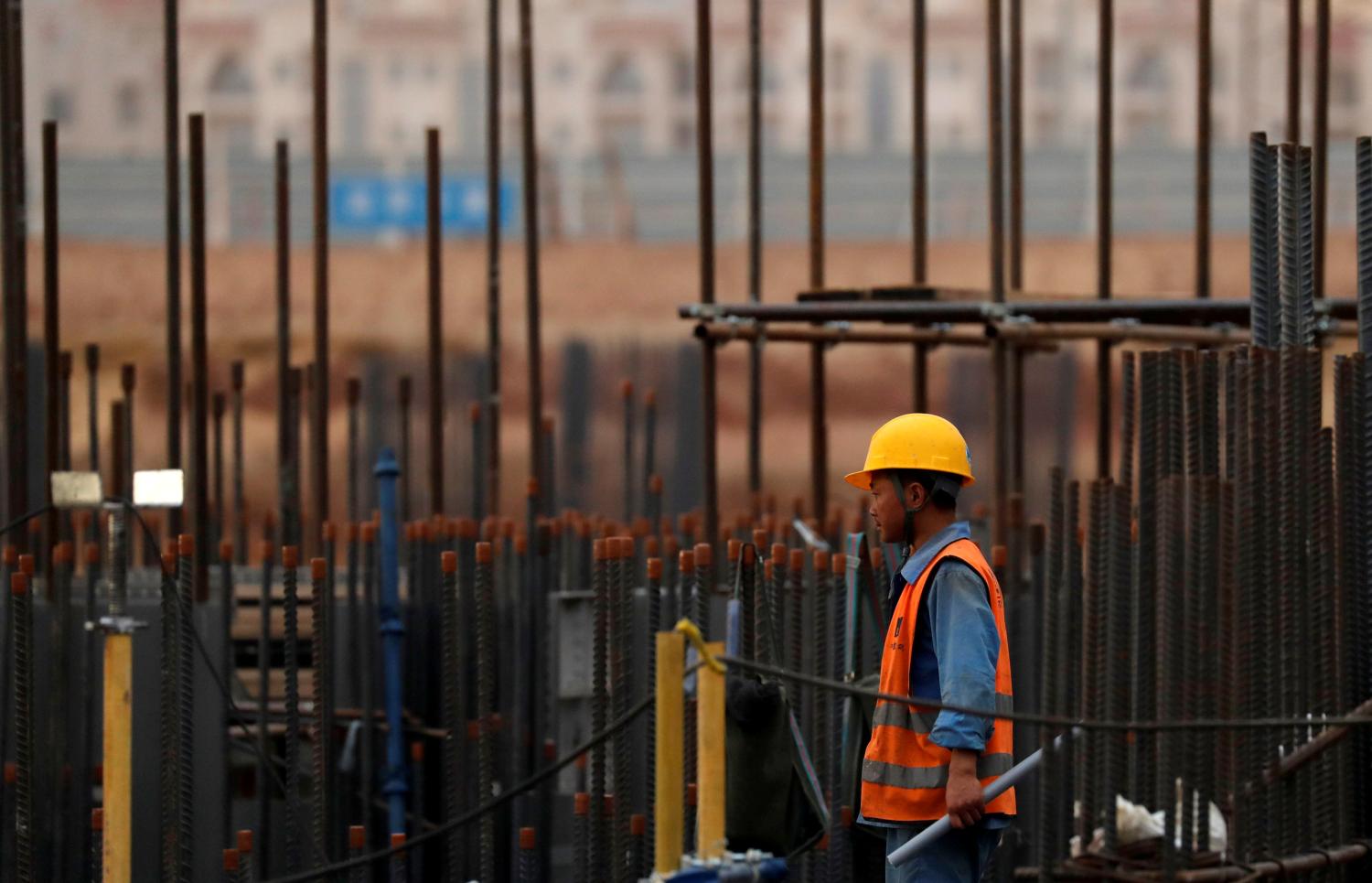 A Chinese construction labourer works at the site of the future Iconic Tower skyscraper, at its foundations in the business district, being built by China State Construction Engineering Corp (CSCEC) in the New Administrative Capital (NAC) east of Cairo, Egypt May 2, 2019. Picture taken May 2, 2019. REUTERS/Amr Abdallah Dalsh - RC143E9C90F0