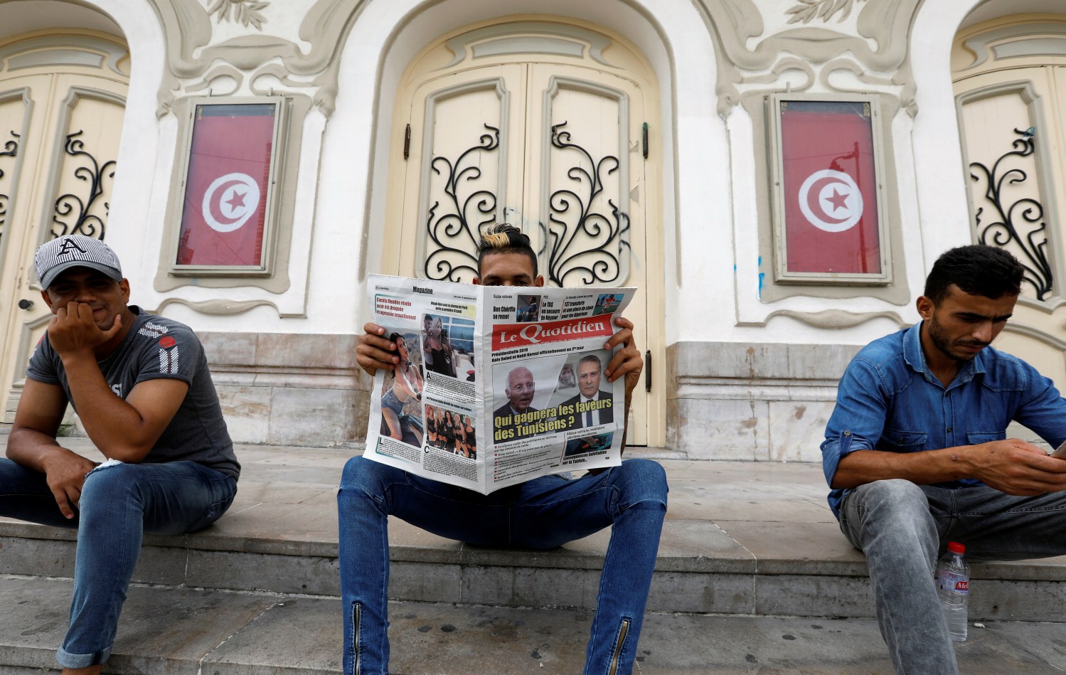 A man reads a local newspaper displaying pictures of two candidates for the second round of Tunisia's presidential election, in Tunis, Tunisia September 18, 2019. REUTERS/Zoubeir Souissi - RC1B2D4B94C0