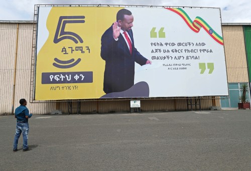 A man looks at a billboard with the image of Ethiopian Prime Minister Abiy Ahmed in Addis Ababa, Ethiopia, October 11, 2019. The billboard reads "Our Justice motto should be love, respect and anchor of morality for all human beings." REUTERS/Tiksa Negeri - RC1FE40221D0