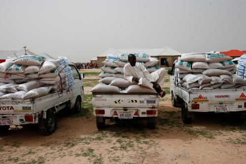 A man rests on a mini truck loaded with bagged food-stuff at a internal displaced persons (IDP) camp during the official flag-off of food and relief materials distribution for the internal displaced persons in Nigerian city of Maiduguri, June 8, 2017.REUTERS/Akintunde Akinleye - RC1CF1A1DD10