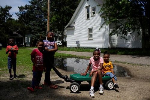 Kids play outside of their home in the West Washington neighborhood in South Bend, Indiana, U.S., June 26, 2019. Picture taken June 26, 2019. REUTERS/Joshua Lott - RC1BE196F320