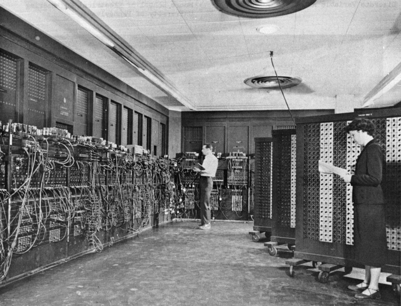 ENIAC (Electronic Numerical Integrator And Computer) in Philadelphia, Pennsylvania. Glen Beck (background) and Betty Snyder (foreground) program the ENIAC in building 328 at the Ballistic Research Laboratory (BRL).