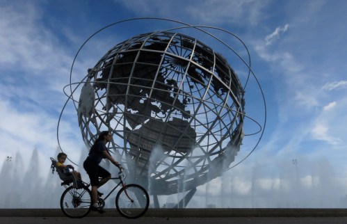 A woman and her son ride past the Unisphere in Flushing Meadows Corona Park in Queens, New York September 5, 2013. New York City is iconic in any weather, but the warm season adds a special flavour to its bustling streets, leafy parks and world-famous skyline. The summer is about to draw to a close, as fall begins in the northern hemisphere with the Autumnal Equinox on September 22. Picture taken September 5, 2013. REUTERS/Gary Hershorn (UNITED STATES - Tags: CITYSCAPE SOCIETY TPX IMAGES OF THE DAY) ATTENTION EDITORS: PICTURE 35 40 FOR PACKAGE 'NYC - A SEASON IN CITY' SEARCH 'NYC HERSHORN' FOR ALL - GM1E99L1AOQ01