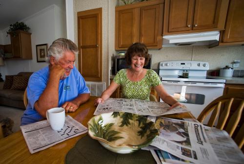 Mark Findlay and his wife Delores Findlay, of Erie, Pennsylvania, read the morning newspaper inside their home at Limetree Park where they spend the winter months in Bonita Springs, Florida, March 23, 2012. Medicare and Social Security, the massive programs that pay benefits to tens of millions of older Americans, are contentious issues in the 2012 presidential campaign. Seniors want the nation?s sputtering economy to be fixed, but not at their expense.   REUTERS/Steve Nesius  (UNITED STATES - Tags: ELECTIONS POLITICS SOCIETY) - TM3E846043F01