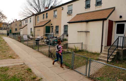 A woman walks on a path in the Berry Farm housing project in Ward 8 of Washington November 20, 2012. Picture taken November 20, 2012. To match Special Report EQUALITY/WASHINGTON  REUTERS/Kevin Lamarque  (UNITED STATES - Tags: SOCIETY BUSINESS EMPLOYMENT POVERTY) - GM1E8CI1MCM01