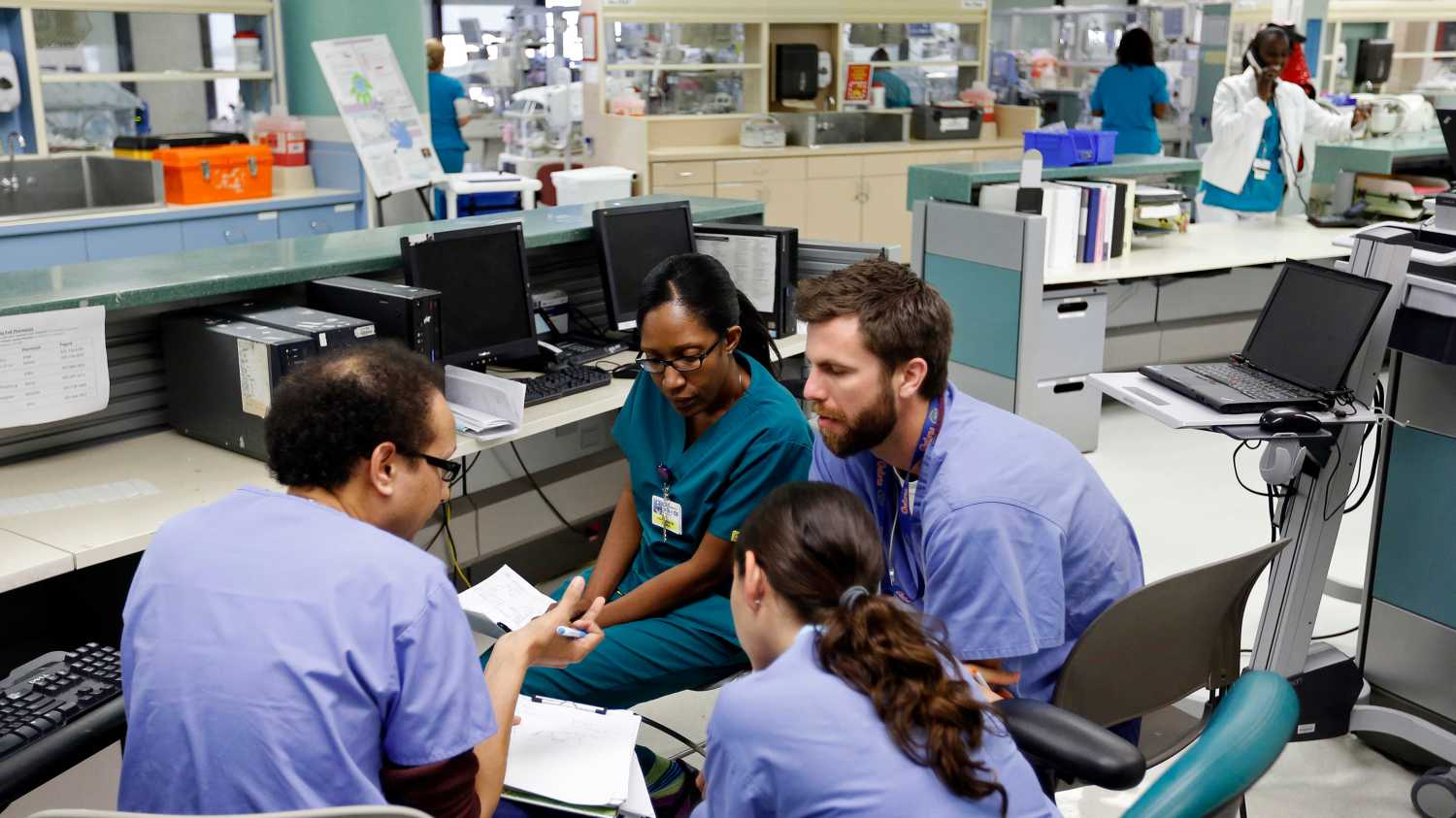 Doctors confer in the neonatal intensive care unit of the Holtz Children's Hospital at Jackson Memorial Hospital in Miami September 30, 2013. The Obama administration accelerated its push to persuade individual Americans to sign up for the most extensive overhaul of the U.S. healthcare system in 50 years, the Affordable Care Act (commonly referred to as "Obamacare"), even as the program's foes in Congress fought to delay its launch with the threat of a federal government shutdown. The Jackson Health System is the largest in Florida and one of the largest in the U.S.  REUTERS/Joe Skipper (UNITED STATES - Tags: HEALTH) - GM1E9A10J3G01