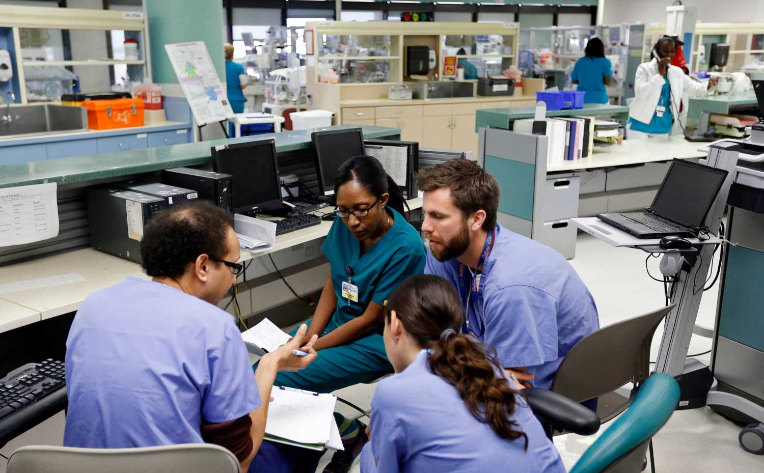 Doctors confer in the neonatal intensive care unit of the Holtz Children's Hospital at Jackson Memorial Hospital in Miami September 30, 2013. The Obama administration accelerated its push to persuade individual Americans to sign up for the most extensive overhaul of the U.S. healthcare system in 50 years, the Affordable Care Act (commonly referred to as "Obamacare"), even as the program's foes in Congress fought to delay its launch with the threat of a federal government shutdown. The Jackson Health System is the largest in Florida and one of the largest in the U.S.  REUTERS/Joe Skipper (UNITED STATES - Tags: HEALTH) - GM1E9A10J3G01