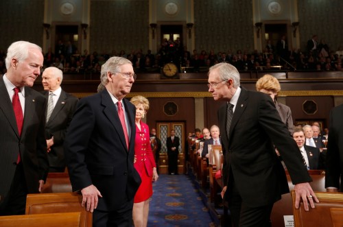 U.S. Senate Minority Whip John Cornyn (L), Senate Minority Leader Mitch McConnell (2nd L) and Senate Majority Leader Harry Reid (R) head to the front of the chamber together before President Barack Obama delivers his State of the Union speech on Capitol Hill in Washington, January 28, 2014. REUTERS/Larry Downing (UNITED STATES  - Tags: POLITICS)   - TB3EA1T07R4IC