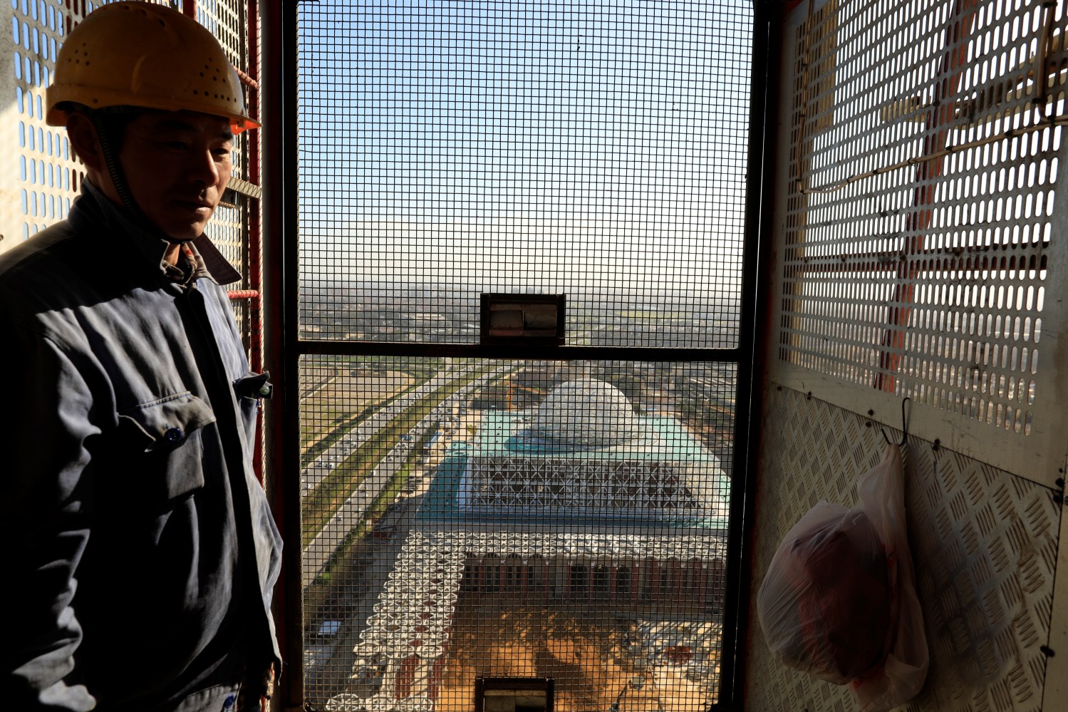 A Chinese worker uses the elevator of the 270-metre-high minaret at the construction site of the new Great Mosque of Algiers, called Djemaa El Djazair, which is being built by the China State Construction Engineering Corporation (CSCEC), and overseen by Algeria's National Agency for Realization and Management (ANERGEMA) in Algiers, Algeria February 7, 2017. REUTERS/Zohra Bensemra - RC190C8B5940