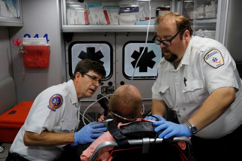 Cataldo Ambulance medics John Gardner (L) and David Farmer care for a man in his 40's who was found unresponsive after overdosing on an opioid in the Boston suburb of Salem, Massachusetts, U.S., August 9, 2017.  The victim received a total of 12mg of naloxone. Nurses at the hospital recognised the man, saying he was brought in the day before after overdosing. REUTERS/Brian Snyder  SEARCH "SNYDER OPIOIDS" FOR THIS STORY. SEARCH "WIDER IMAGE" FOR ALL STORIES. - RC18CB977100