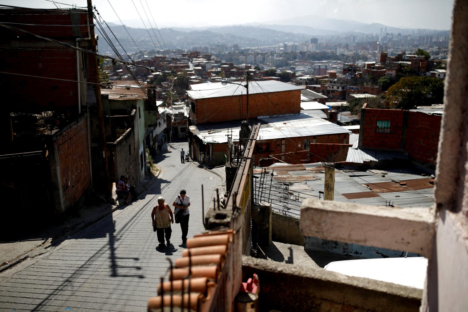 Yaneidi Guzman, 38, walks home with her mother-in-law in Caracas, Venezuela, February 17, 2019. Guzman has lost a third of her weight over the past three years as Venezuela's economic collapse made food unaffordable and she now hopes the opposition will succeed in bringing urgently needed foreign aid. She is one of many Venezuelans suffering from malnutrition. "It's not that I want to be rich, or a millionaire", Guzman said. "But I do want to give my children a good future, to make sure I can take them to the doctors when they get ill... and that they eat well." REUTERS/Carlos Garcia Rawlins  SEARCH "RAWLINS GUZMAN" FOR THIS STORY. SEARCH "WIDER IMAGE" FOR ALL STORIES. - RC1F8A0356E0