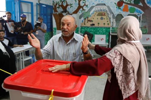 A man gestures after casting his ballot at a polling station during parliamentary elections, in Tunis, Tunisia October 6, 2019. REUTERS/Zoubeir Souissi - RC1CA224E2B0