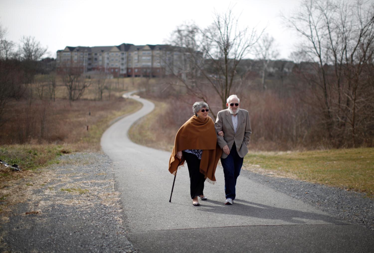Retired couple Harvey and Cora Alter take a walk in their planned-community in semi-rural Frederick, Maryland March 2, 2012. Moving in retirement to save money - but not that far from previous homes, is a trend where retirees want to reduce the cost of living but not uproot their lives completely. Picture taken March 2, 2012. To match feature USA-RETIREES/     REUTERS/Jason Reed   (UNITED STATES - Tags: SOCIETY BUSINESS) - GM1E839043S01