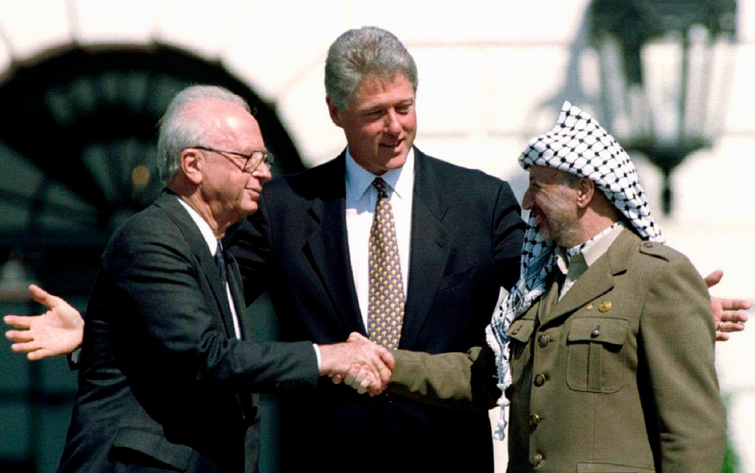 U.S. President Bill Clinton (C) looks on as Israeli Prime Minister Yitzhak Rabin (L) and Palestine Liberation Organization (PLO) leader Yasser Arafat shake hands after the signing of the Israeli-PLO peace accord at the White House in this September 13, 1993 file photo. REUTERS/Gary Hershorn/Files (UNITED STATES - Tags: POLITICS TPX IMAGES OF THE DAY)ATTENTION EDITORS - THIS PICTURE IS PART OF PACKAGE '30 YEARS OF REUTERS PICTURES'TO FIND ALL 56 IMAGES SEARCH '30 YEARS' - LM2EB2A0WTA01