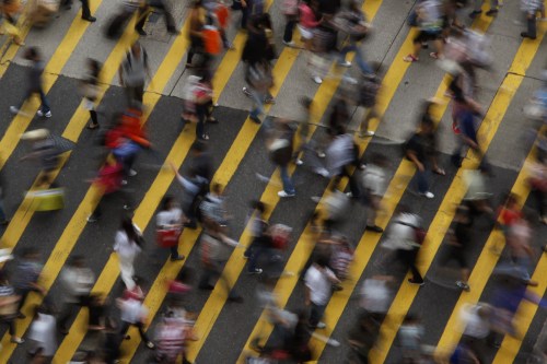 ATTENTION EDITORS - IMAGE 1 OF 22 OF PICTURE PACKAGE '7 BILLION, 7 STORIES - OVERCROWDED IN HONG KONG. SEARCH 'MONG KOK' FOR ALL IMAGES - People cross a street in Mong Kok district in Hong Kong, October 4, 2011. Mong Kok has the highest population density in the world, with 130,000 in one square kilometre. The world's population will reach seven billion on 31 October 2011, according to projections by the United Nations, which says this global milestone presents both an opportunity and a challenge for the planet. While more people are living longer and healthier lives, says the U.N., gaps between rich and poor are widening and more people than ever are vulnerable to food insecurity and water shortages.   Picture taken October 4, 2011.   REUTERS/Bobby Yip   (CHINA - Tags: SOCIETY) - LM2E7AE147B01