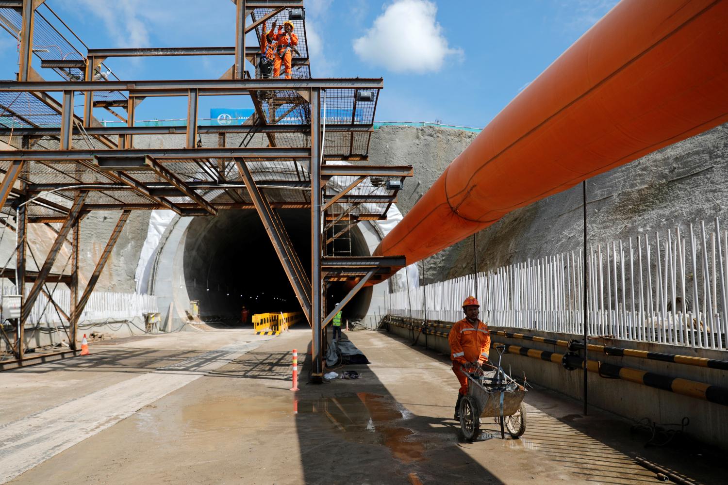 A worker pushes a wheelbarrow at Walini tunnel construction site for Jakarta-Bandung High Speed Railway in West Bandung regency, West Java province, Indonesia, February 21, 2019. Picture taken February 21, 2019. REUTERS/Willy Kurniawan - RC162D22E8C0