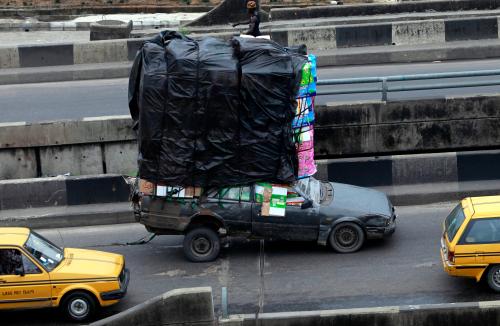 A car, loaded with household wares, drives up a bridge at the Orile-Iganmu district of Lagos August 29, 2013. With between 15 million and 21 million people - the upper estimate is the official one, though no one really knows - and generating a third of GDP for Africa's second biggest economy, Lagos has become almost as alluring to yield-hungry investors as it is to the 4,000 or so economic migrants who turn up each day. But it faces a daily challenge just trying to keep up with the pace of population growth, much of it on the edge of water. Nigeria, already pushing 170 million people, will be home to 400 million by 2050, making it the world's fourth most populous country, according to the global Population Reference Bureau (PRB). Lagos will have roughly doubled in size by then, Fashola and demographers agree. Picture taken August 29, 2013. To match Insight LAGOS-MEGACITY/    REUTERS/Akintunde Akinleye (NIGERIA - Tags: SOCIETY BUSINESS EMPLOYMENT) - GM1E9AN0J6401