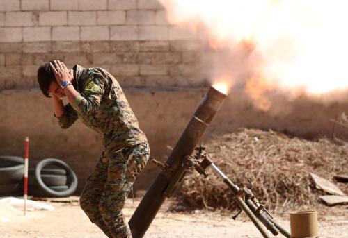 A Kurdish fighter from the People's Protection Units (YPG) fires a 120 mm mortar round in Raqqa, Syria, June 15, 2017. REUTERS/Goran Tomasevic TPX IMAGES OF THE DAY - RC174C20EA30