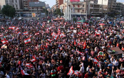 Demonstrators carry national flags during an anti-government protest in Tripoli, Lebanon October 22, 2019. REUTERS/Omar Ibrahim - RC1D594342A0