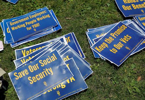 Signs are pictured on the ground during a noon-time rally of federal employees on Independence Mall to protest proposed cuts in federal funding in Philadelphia, Pennsylvania, U.S., June 22, 2017. They claim the cuts will eliminate jobs in the Environmental Protection Agency, Social Security Administration, Veterans Administration and National Park Service. REUTERS/Tom Mihalek - RC1946722230