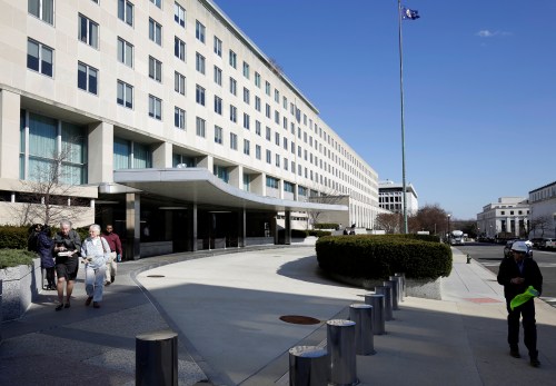 People walk past the State Department Building in Washington, U.S., January 26, 2017. REUTERS/Joshua Roberts - RC1975B72C30