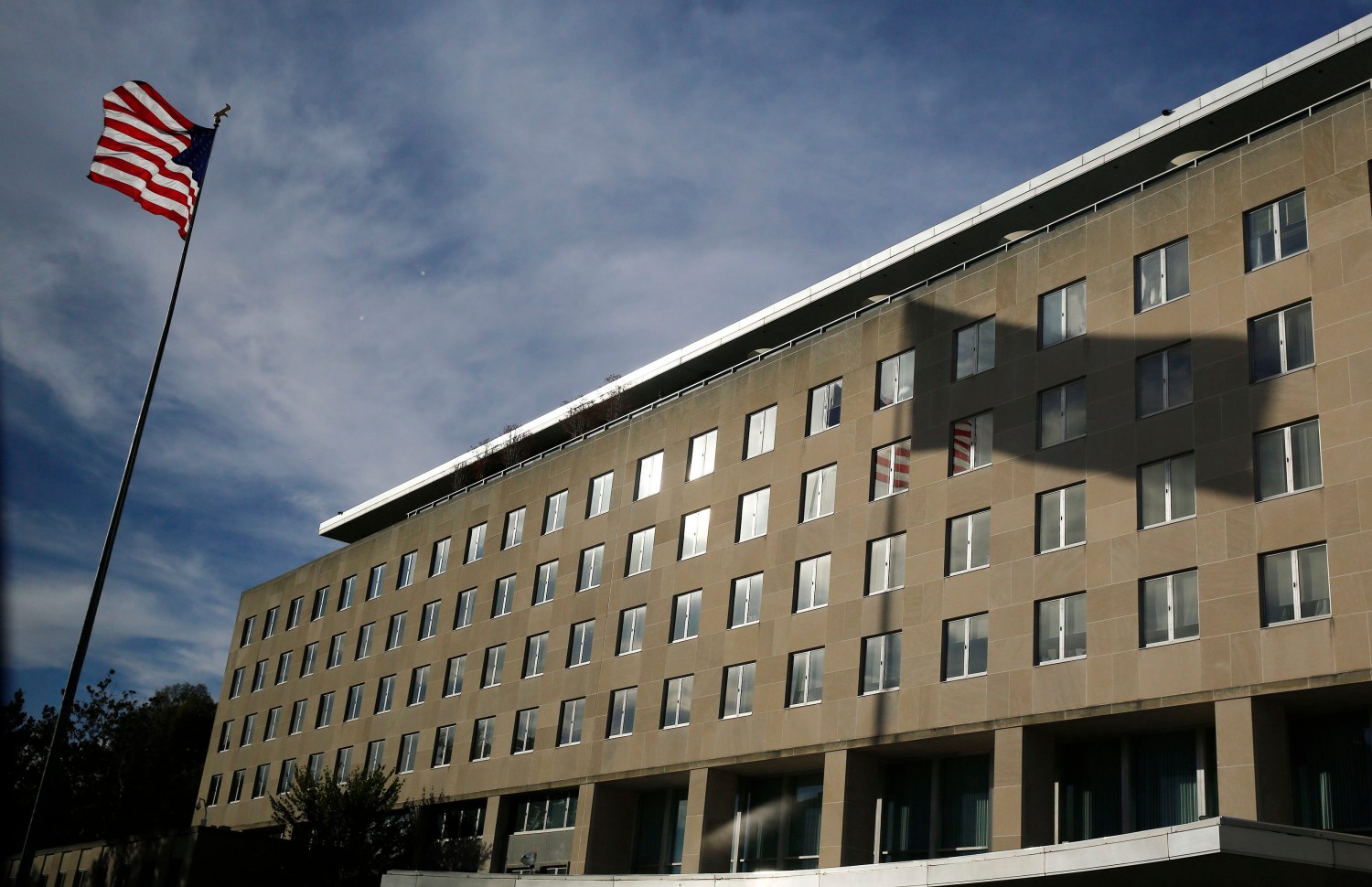 A U.S. national flag and its shadow falling on the Harry S. Truman Building at the Department of State are seen in Washington, October 24, 2014.      REUTERS/Larry Downing   (UNITED STATES - Tags: POLITICS SOCIETY) - GM1EAAP0DNZ01