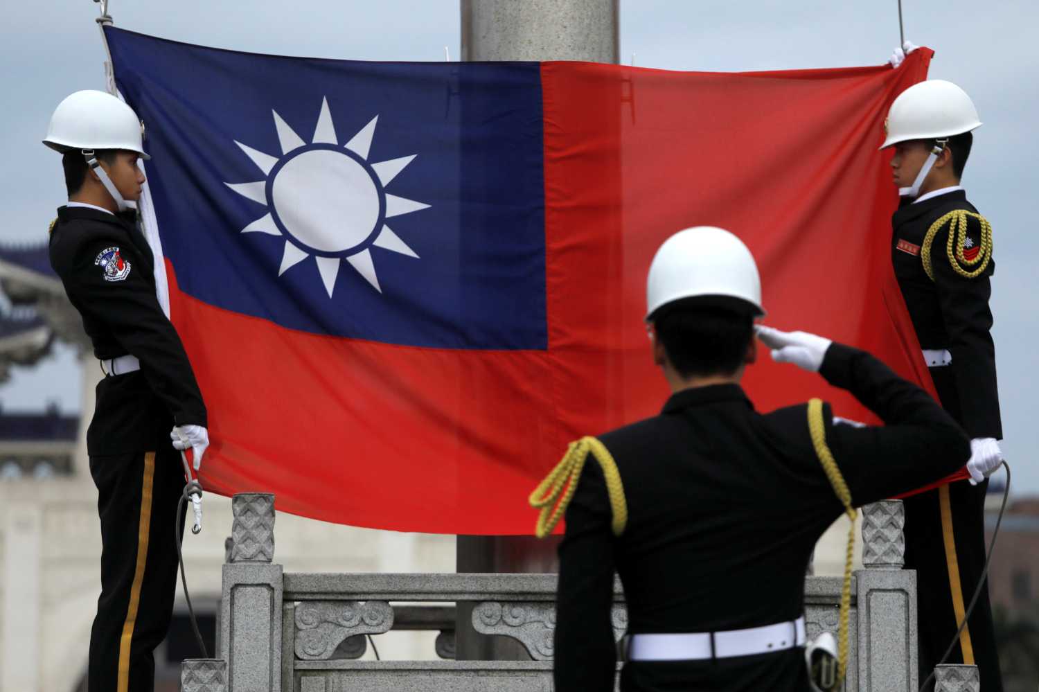 Military honour guards attend a flag-raising ceremony at Chiang Kai-shek Memorial Hall, in Taipei, Taiwan March 16, 2018. REUTERS/Tyrone Siu - RC1C0F6CE3E0