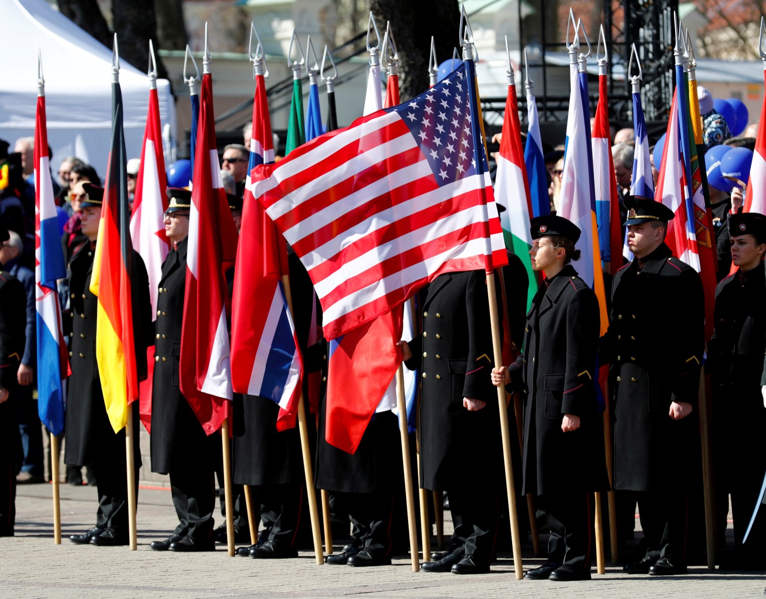 Lithuanian Military Academy students hold NATO membership states flags during the celebration of the the 15th anniversary of Lithuania's membership in NATO in Vilnius, Lithuania March 30, 2019. REUTERS/Ints Kalnins - RC1B87408B50