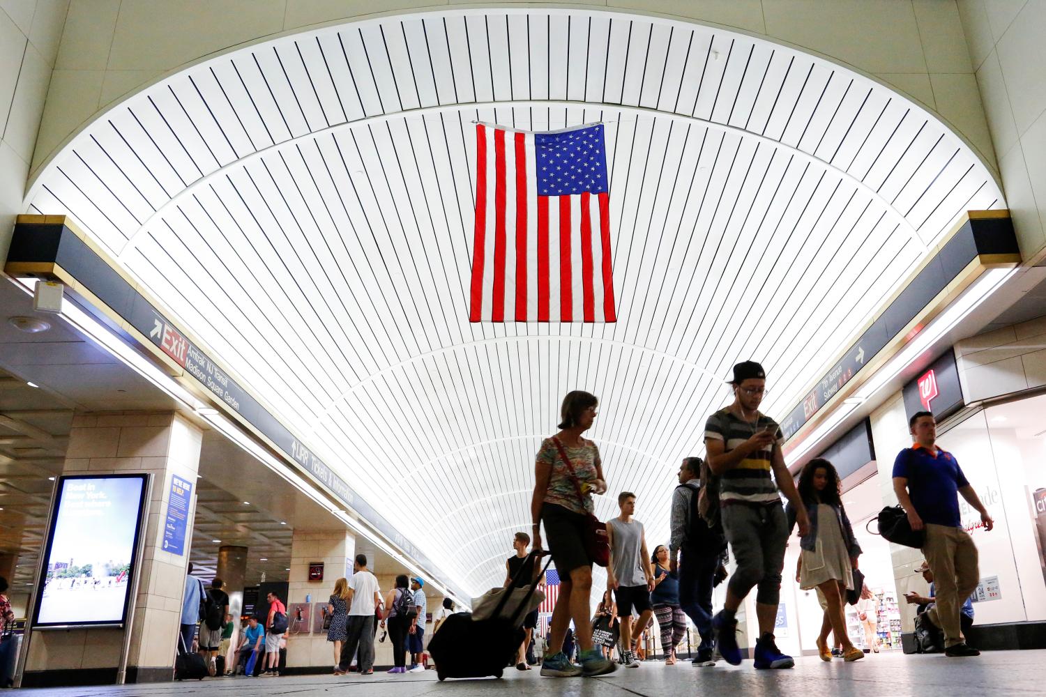 Commuters walk through New York's Pennsylvania Station, the nation's busiest train hub, which will be closing tracks for repairs and causing massive disruptions to commuters in New York City, U.S., July 9, 2017. REUTERS/Eduardo Munoz - RC170CEFD710