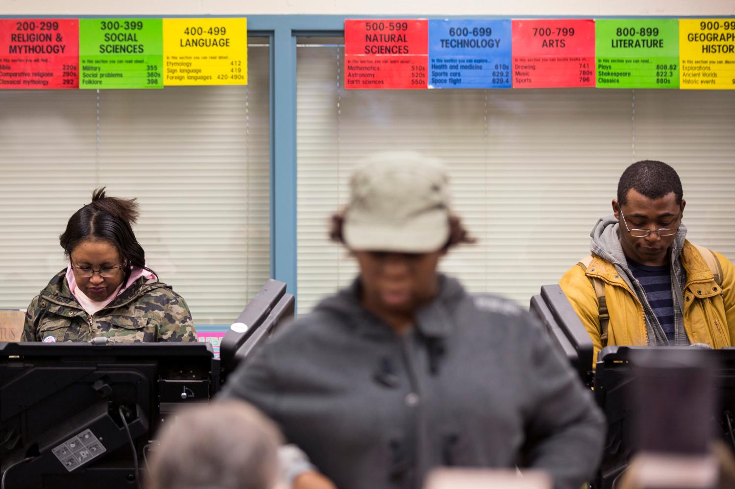 Voters cast their ballot in the U.S. midterm elections in Ferguson, Missouri November 4, 2014. Black anger at a local Democrat's handling of the shooting of teenager Michael Brown in Ferguson, Missouri, has given the Republican candidate some hope of winning the race for St Louis County executive for first time since the 1980s. REUTERS/Whitney Curtis  (UNITED STATES - Tags: POLITICS ELECTIONS) - GM1EAB50DEP01