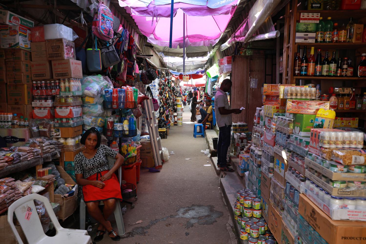 A woman sits near food items displayed for sale at a market in Abuja, Nigeria October 10, 2019. Picture taken October 10, 2019. REUTERS/Afolabi Sotunde - RC116DF3C490