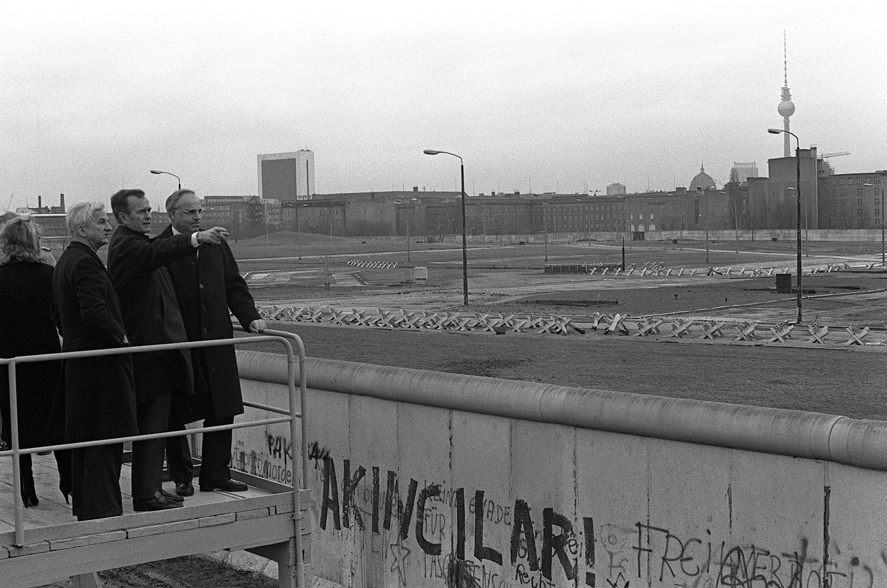 West German Chancellor Helmut Kohl and Berlin Mayor Richard von Weizsäcker show the Berlin Wall to U.S. Vice President George H.W. Bush on January 21, 1983. (National Archives)