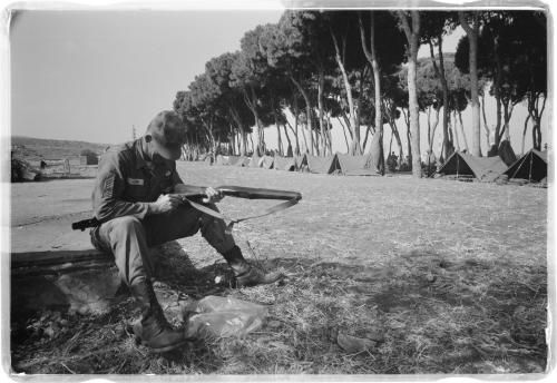 American paratrooper cleans his gun at Army base camp in Beirut, Lebanon. Credit: Library of Congress
