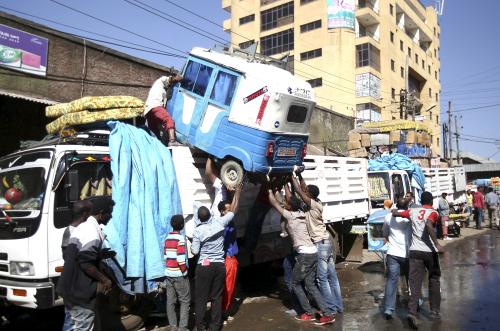 Labourers load a three-wheeled vehicle onto the back of a van at the Mercato market in Addis Ababa October 9, 2015. Addis Ababa's 'Mercato' - Italian for 'market' - is reputedly the biggest open-air market in Africa, lying in the west of the capital. Supermarkets have sprouted across the city as the metropolis has expanded with Ethiopia's booming economy, but Mercato remains a popular destination for shoppers seeking clothing, electronics and a huge range of other items. It has been around for as long as the city, which was founded at the end of the 19th century, but it took its current form, and its name, from the Italians who invaded Ethiopia in 1935. The Italian occupation ended in 1941. Picture taken October 9, 2015.    REUTERS/Tiksa Negeri  - GF10000267957