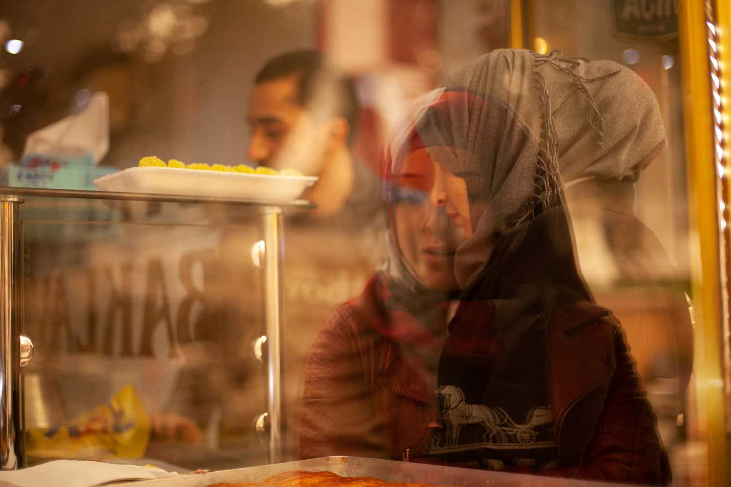 Palestinian-Syrian refugee Ahmed, 27, his future wife Hanin, 18, and Hanin's mother Turki visit a pastry shop the day before their engagement party in Kilis, Turkey, March 10, 2017. Ahmed's and Hanin's journey started amid Syria's conflict and brought the two Palestinians from their homes in Damascus' suburbs to Turkey. They were introduced in the winter of 2017. As they lived in different cities, they texted for months before Ahmed took a 20-hour bus trip from Izmir to the border town of Kilis to meet her, which led to their engagement. REUTERS/Ekaterina Anchevskaya     SEARCH "SYRIA MIGRANTS" FOR THIS STORY. SEARCH "WIDER IMAGE" FOR ALL STORIES. - RC1460F5A5A0