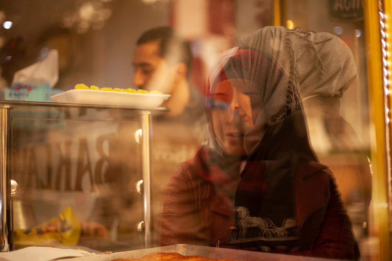 Palestinian-Syrian refugee Ahmed, 27, his future wife Hanin, 18, and Hanin's mother Turki visit a pastry shop the day before their engagement party in Kilis, Turkey, March 10, 2017. Ahmed's and Hanin's journey started amid Syria's conflict and brought the two Palestinians from their homes in Damascus' suburbs to Turkey. They were introduced in the winter of 2017. As they lived in different cities, they texted for months before Ahmed took a 20-hour bus trip from Izmir to the border town of Kilis to meet her, which led to their engagement. REUTERS/Ekaterina Anchevskaya     SEARCH "SYRIA MIGRANTS" FOR THIS STORY. SEARCH "WIDER IMAGE" FOR ALL STORIES. - RC1460F5A5A0