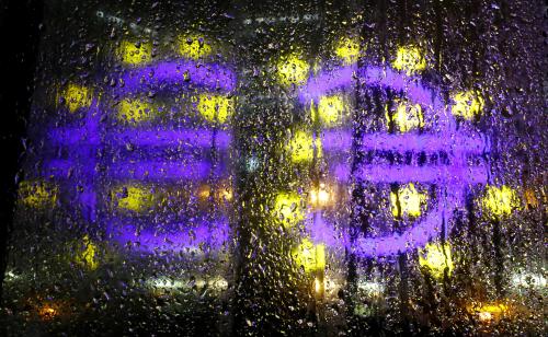 The euro sign in front of the former headquarters of the European Central Bank (ECB) is reflected in a rain covered window during heavy rain in Frankfurt, Germany, November 20, 2017.  REUTERS/Kai Pfaffenbach - RC1F8AC74E00