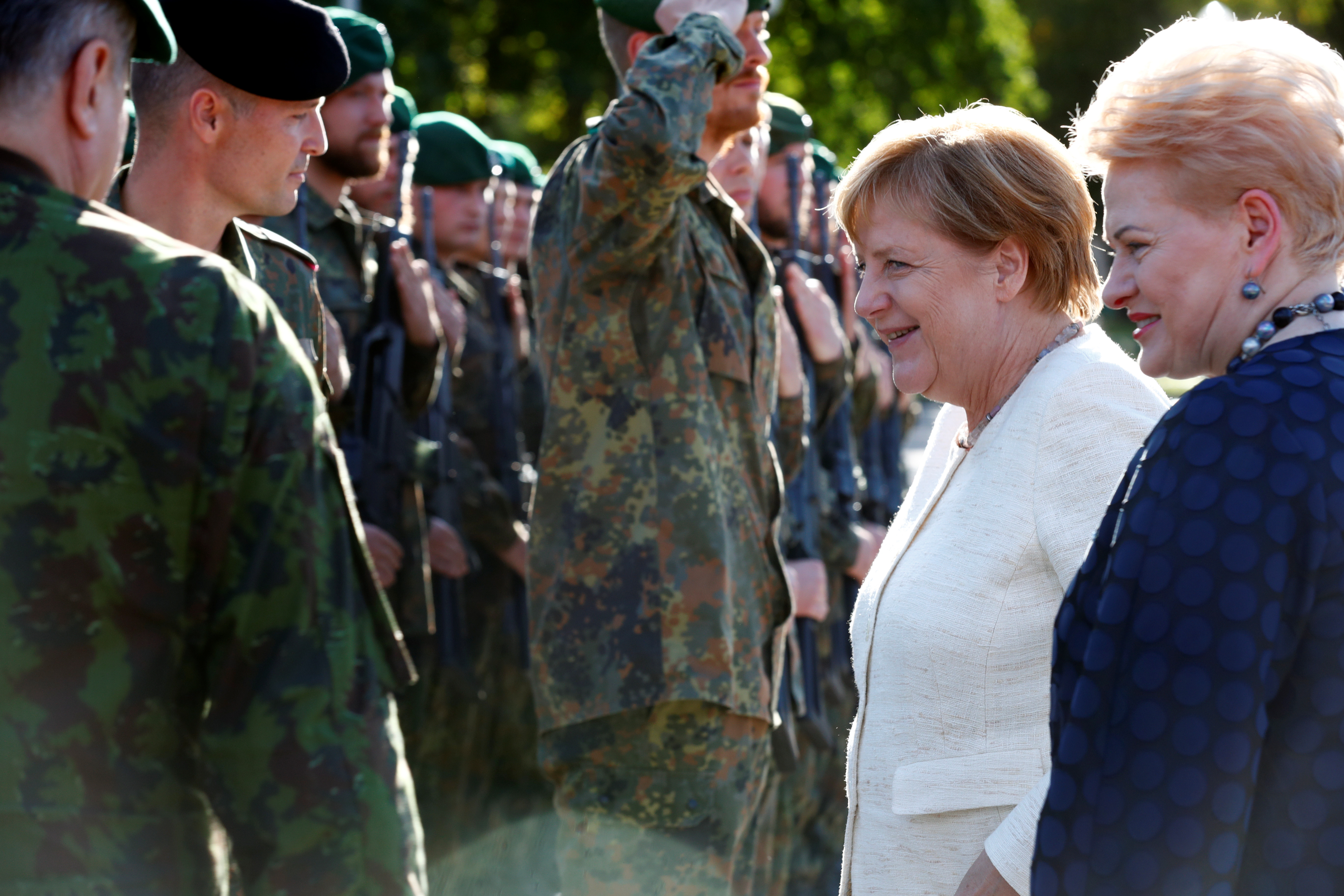 German Chancellor Angela Merkel and then-Lithuanian President Dalia Grybauskaitė visit German NATO troops deployed in Lithuania. (Ints Kalnins/Reuters)