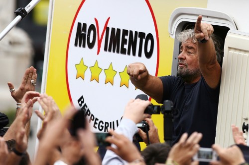 Five-Star Movement activist and comedian Beppe Grillo gestures as he arrives for a rally in the Sicily town of Termini Imerese, Italy October 22, 2012. REUTERS/Massimo Barbanera/File Photo - D1AETJWGKRAB